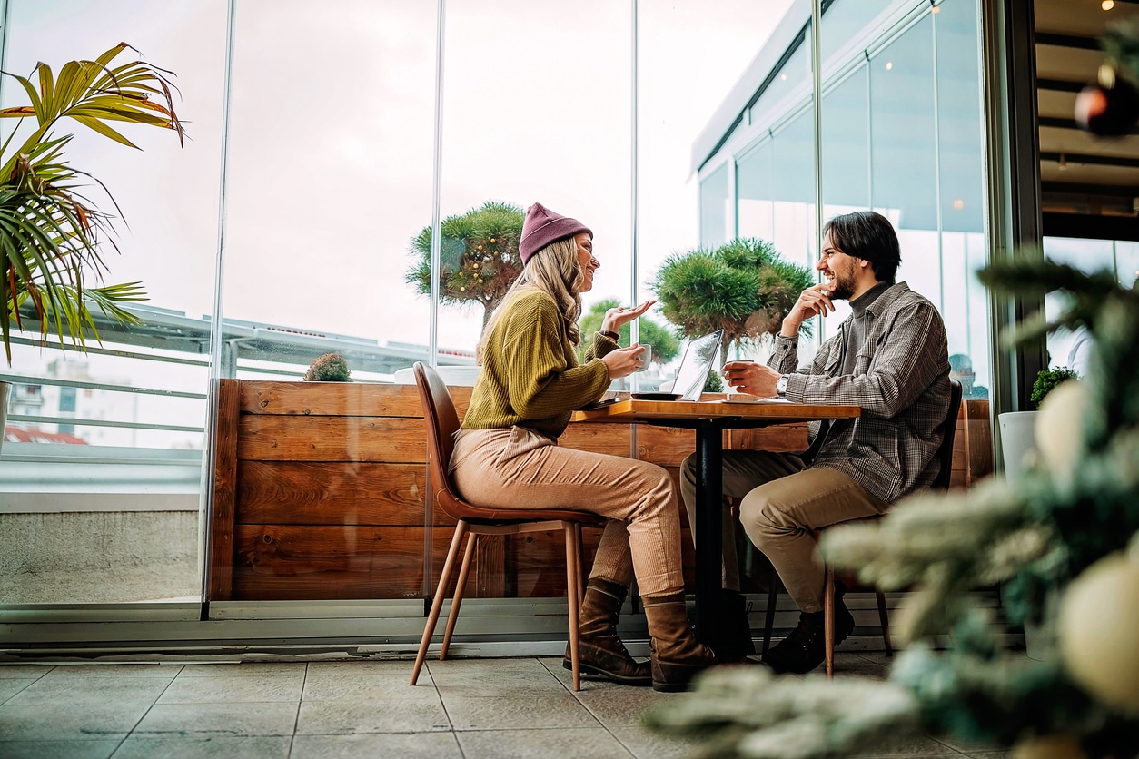 Young professionals socialising at a coffee shop during their meeting for a change of scenery