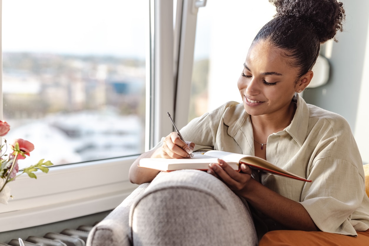 Young woman writing notes about key mental health terms