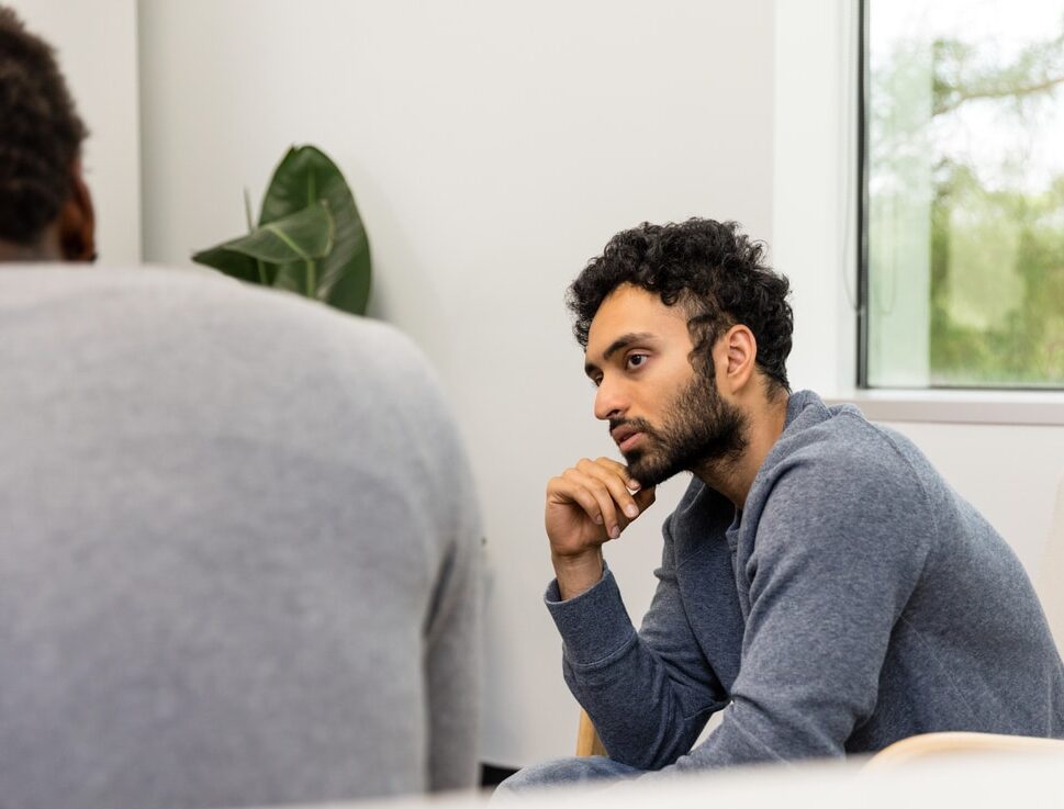 Young man in discussion to understand the three e's of trauma