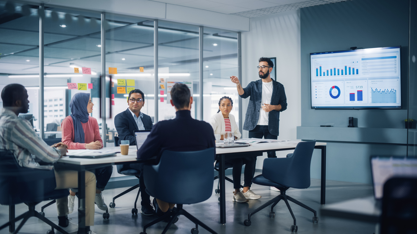 Young business man giving a presentation at a work meeting