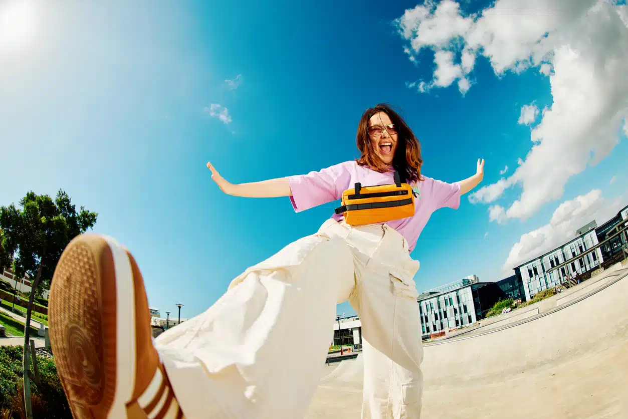 Young, Gen Z woman in the skatepark being happy and playful