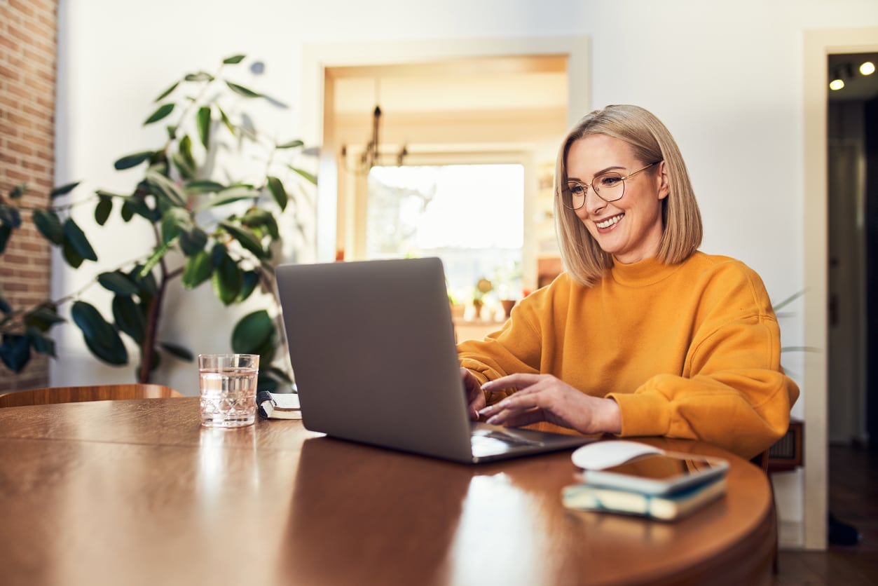 Woman smiling while interacting with online learning community