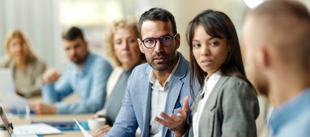 Colleagues having a discussion at work and a manager trying to manage conflict between two coworkers