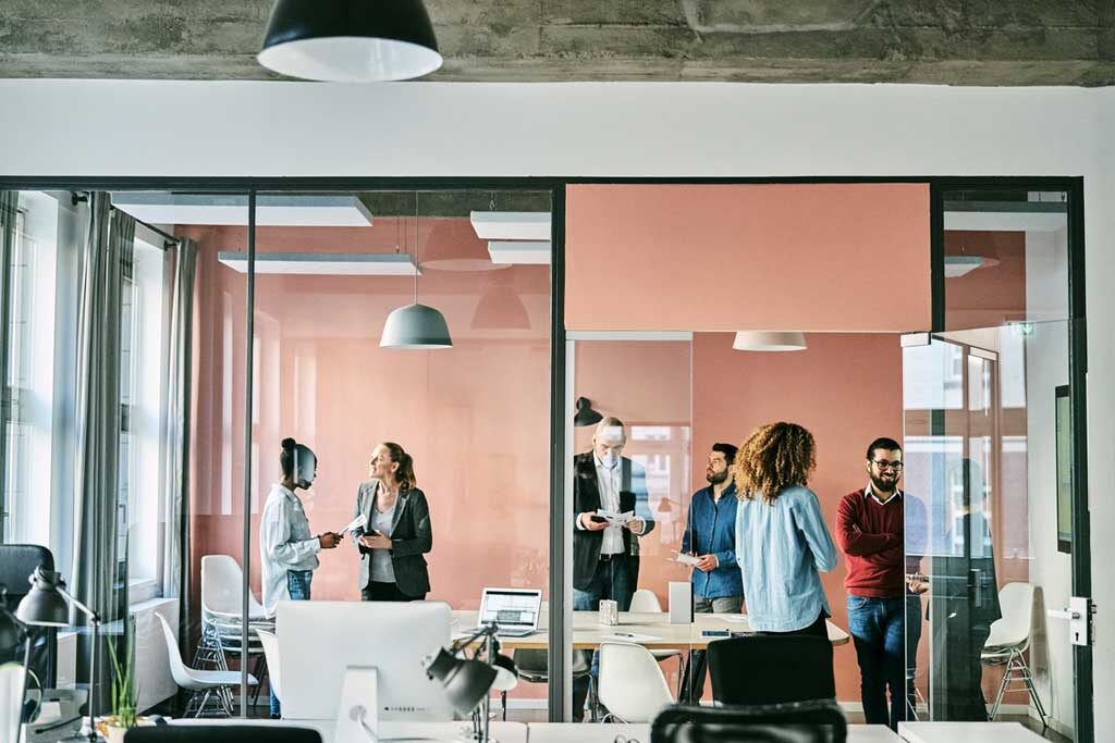 
		Group of business people standing in office boardroom after meeting		