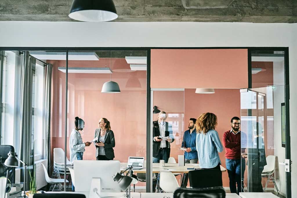 Group of business people standing in office boardroom after meeting