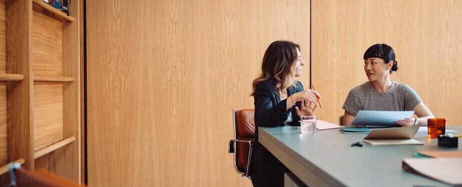 Two Businesswomen Having a Meeting in a Modern Office