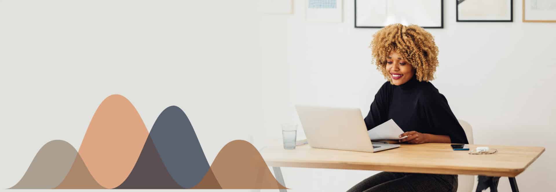 Professional woman working on laptop and smiling