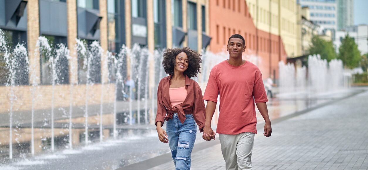 Young couple walking, holding hands