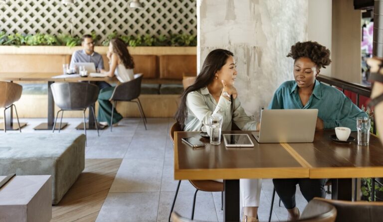 Two women having a meeting in a coffee shop without prejudice in an inclusive society