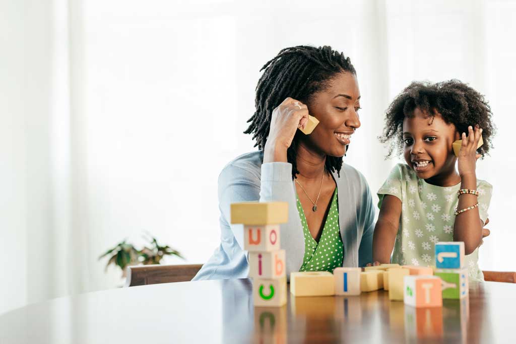 
		Learning moments, mom and kid playing together with wooden blocks		