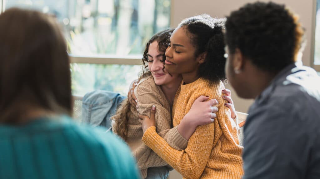 Young women embracing each other