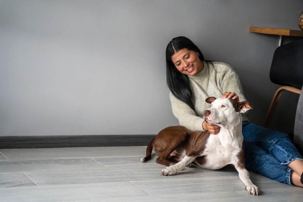 Woman sharing with dog at home