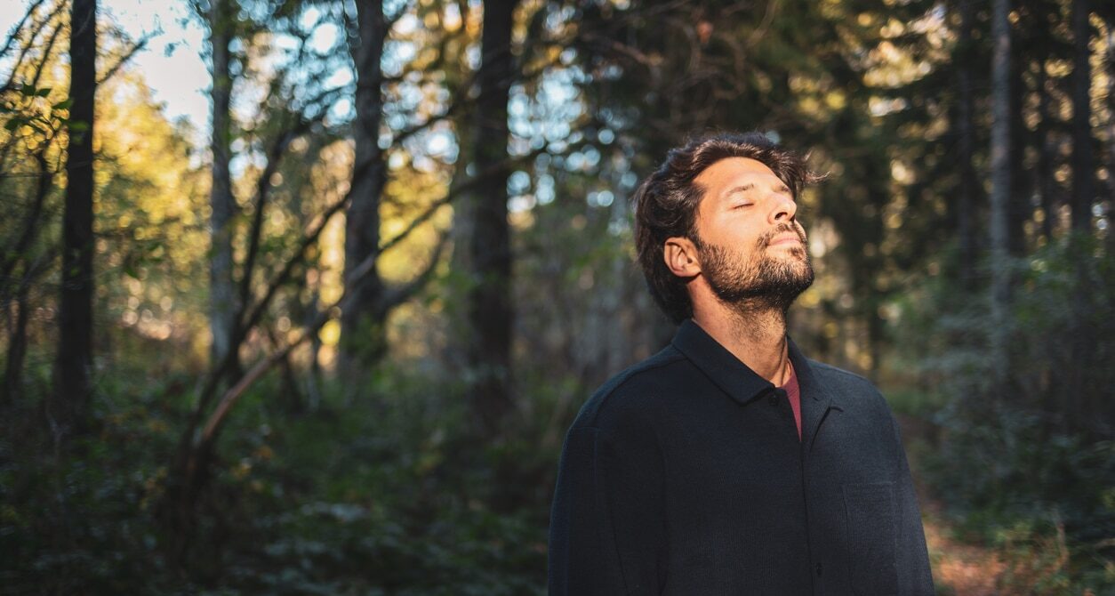 Man in the forest focusing on mental health and wellbeing