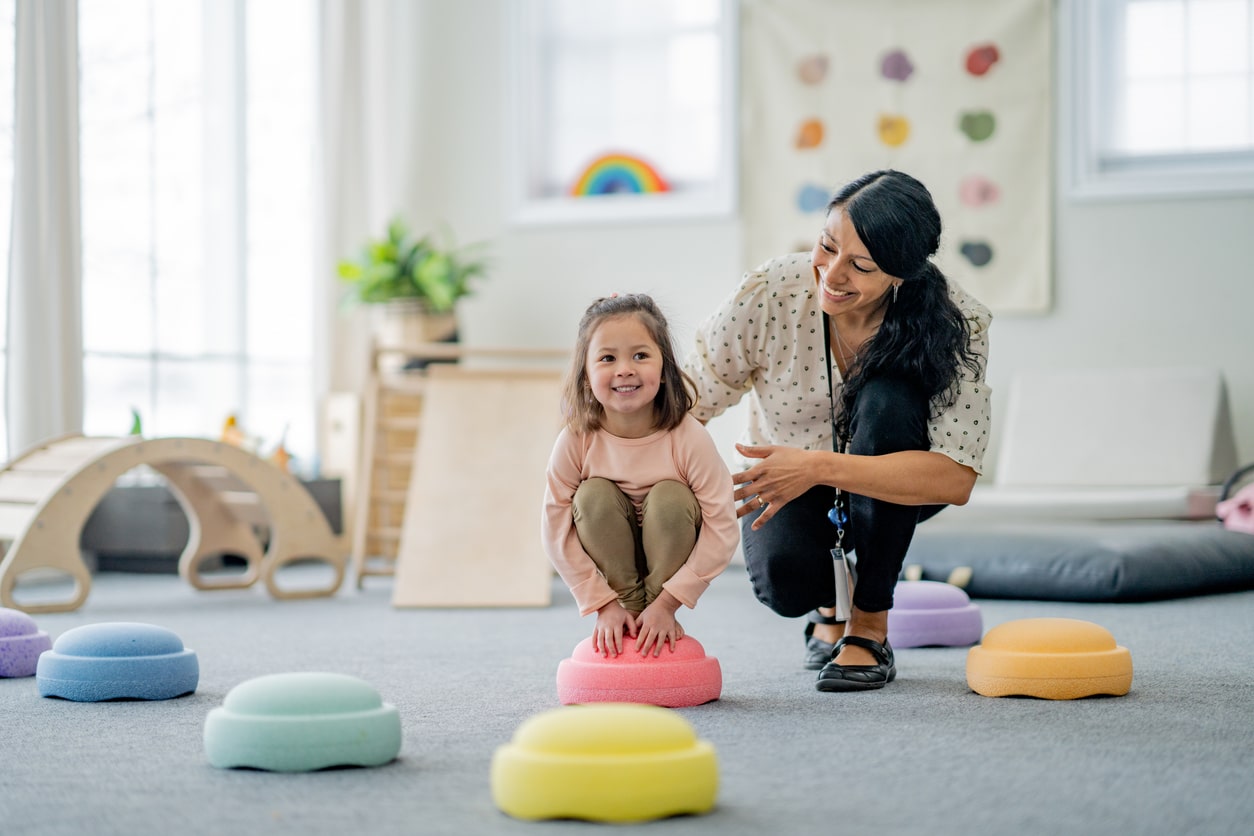 A female working with a child through play therapy