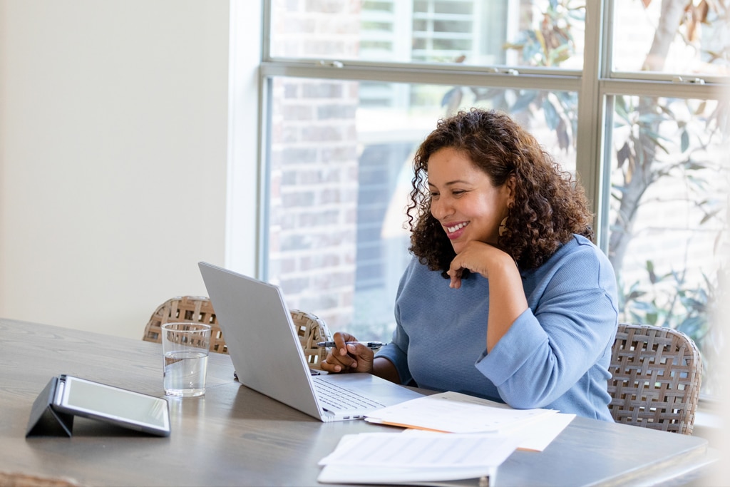 
		A women sitting in an office, working on her lesson plan and is staring at her work on her laptop		