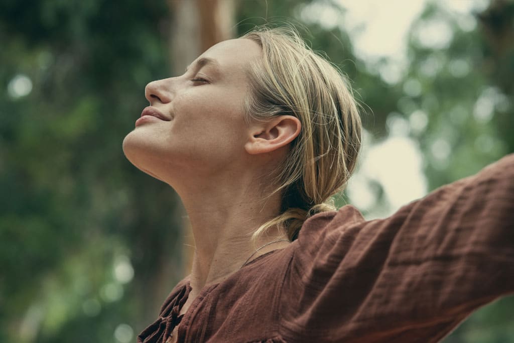 Relaxed woman breathing fresh air outdoors